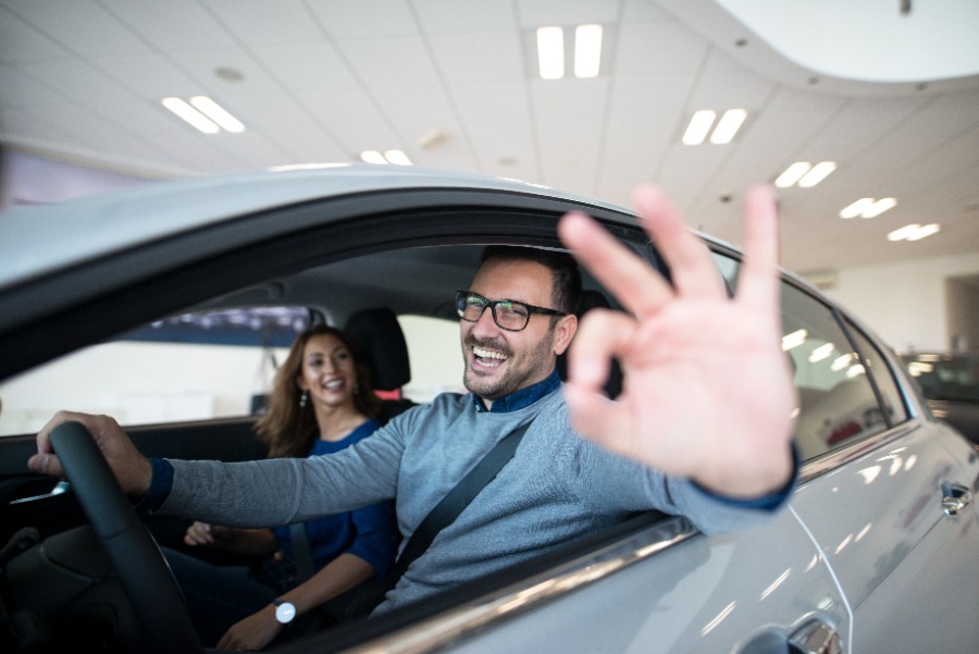 Happy person with his insured car