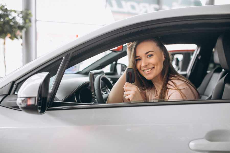 Woman in a car with insurance