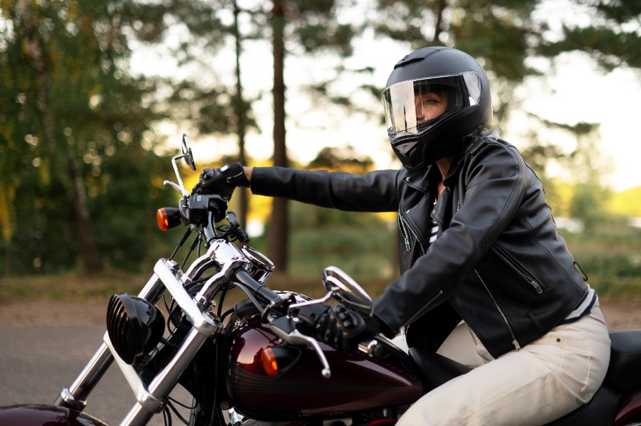 side view senior woman with motorcycle