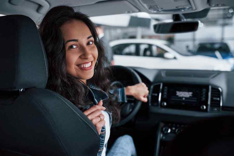 Beautiful woman in car with insurance